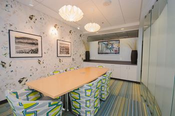 a meeting room with a long table and chairs